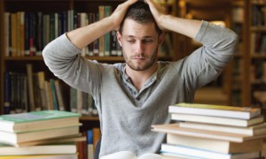 Tired student with books