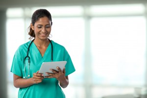 Portrait of a Female Indian doctor holding a digital tablet.